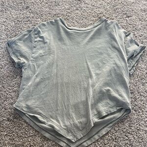 Loose shirt with a v bottom. Light gray with a slight green tint